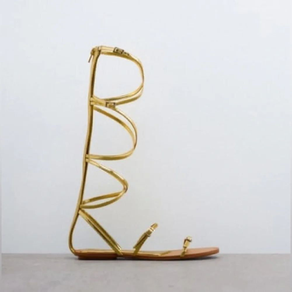 NWT. Zara Golden Strappy Flat Sandals with Buckle Details. Size 7,5.